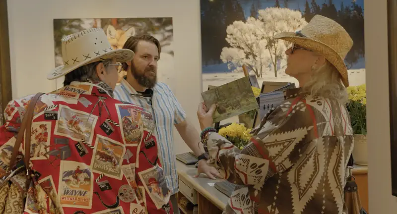 Two people wrapped in bear-print quilts at a screening event